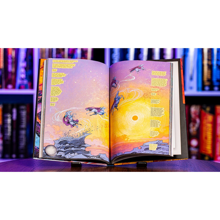 Supergirl deluxe edition comic open to a wide double page spread showing Kara Zor El in space with detailed artwork and bold colors from Supergirl Woman of Tomorrow